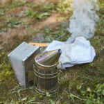 beekeeping smoker smoking on the ground